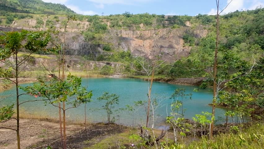 Coloured lake of water at the bottom of Panguna mine pit in Bougainville, Papua New Guinea