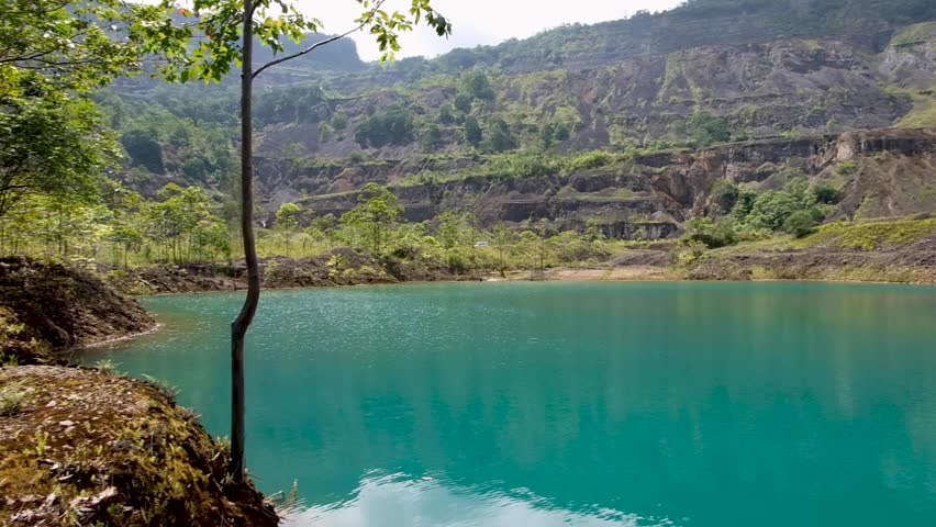 Blue green coloured lake within Panguna mine pit in Bougainville, Papua New Guinea