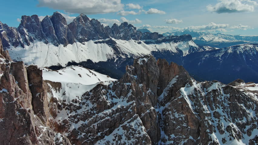 Aerial view of majestic rocky mountains in snow Alps, Dolomites, Italy, 4k