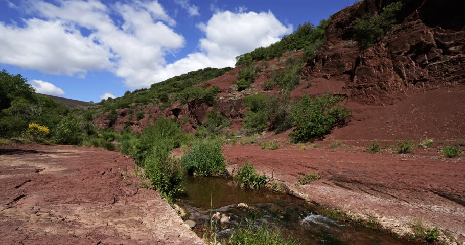 Red landscape surrounding the artificial lake of Salagou, Occitania, Southern France.