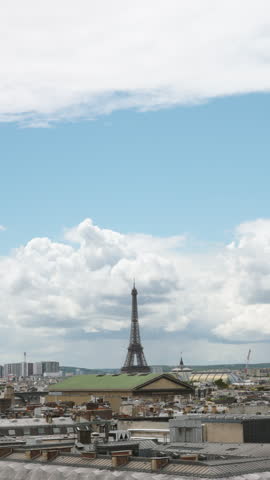Vertical Shot of Paris Skyline with Eiffel Tower under Large Overcast Sky