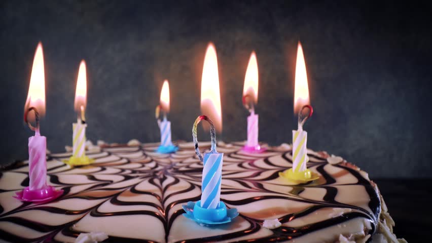 Birthday cake with lit candles, celebration and festive mood.