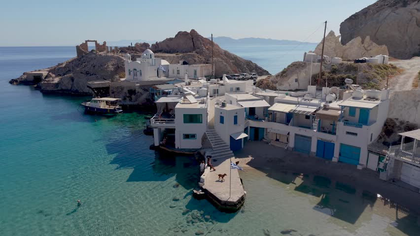 Explore the stunning coastal views of Firopotamos Milos, Greece, featuring traditional whitewashed buildings and crystal-clear waters