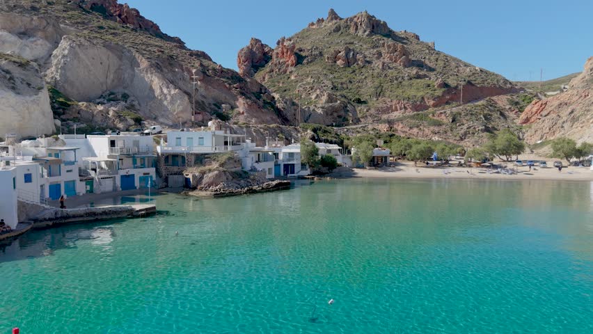 Explore the picturesque shores of Firopotamos Milos Island with turquoise waters lapping against charming white buildings nestled by the stunning hills. Experience the perfect escape in Greece