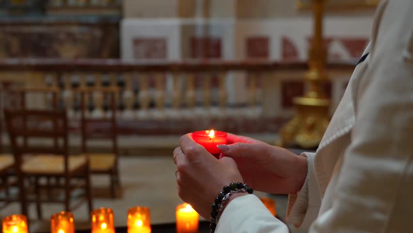 Hands Holding Devotional Candle Inside Royal Chapel at Versailles