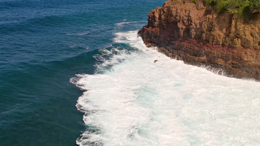 Aerial view of ocean waves and the rugged shoreline of the Big Island of Hawaii