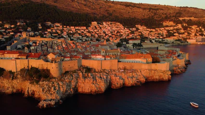 Aerial view of the historical old town of dubrovnik, croatia. The iconic city walls and buildings glowing in the warm golden light of sunset