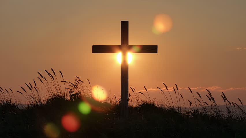 Silhouette of a wooden Christian cross against a beautiful sunset sky