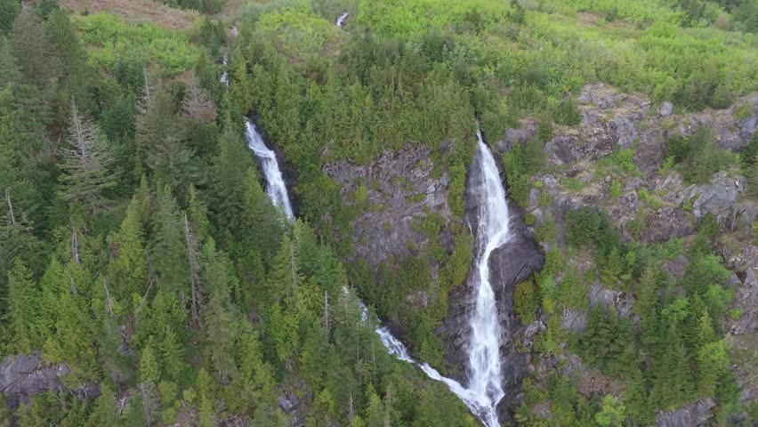 Majestic Twin Waterfalls Cascade Down Lush Green Mountainside in British Columbia, Canada