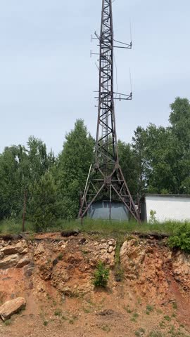 A tall communication tower stands against a cloudy sky in Gorno-Altaysk, Republic of Altai, Russia