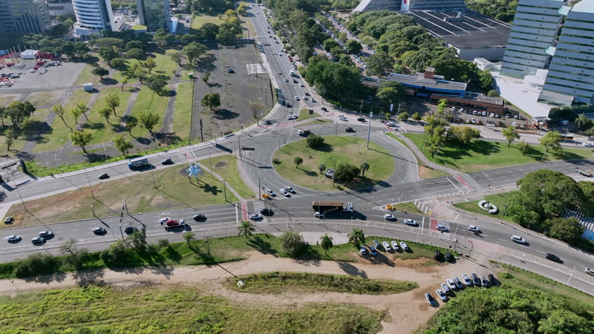 Edvaldo Pereira Paiva avenue roundabout to Porto Alegre downtown skyline with tilt up.