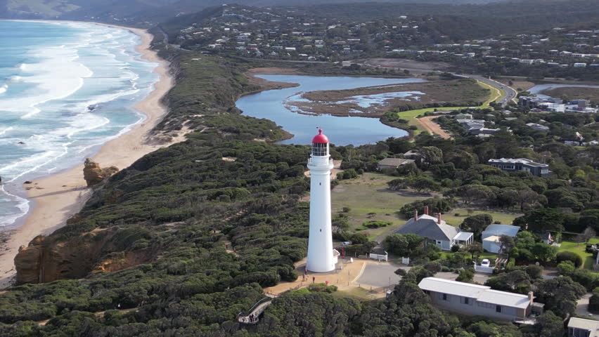 Drone panorama of Aireys Inlet Lighthouse in Victoria Australia featuring dramatic cliffs ocean coastline and scenic travel destination views