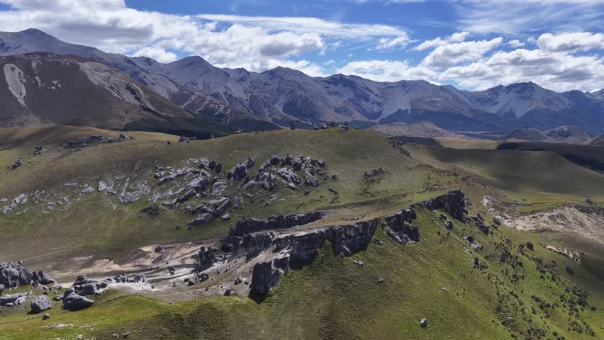 Drone flight over rugged mountain ridges and open alpine terrain on New Zealand