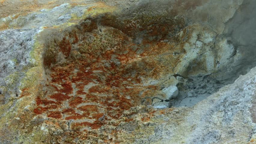 Steam Rising From Boiling Mudpots With Colorful Mineral Deposits In Lassen Volcanic National Park, California. - closeup shot