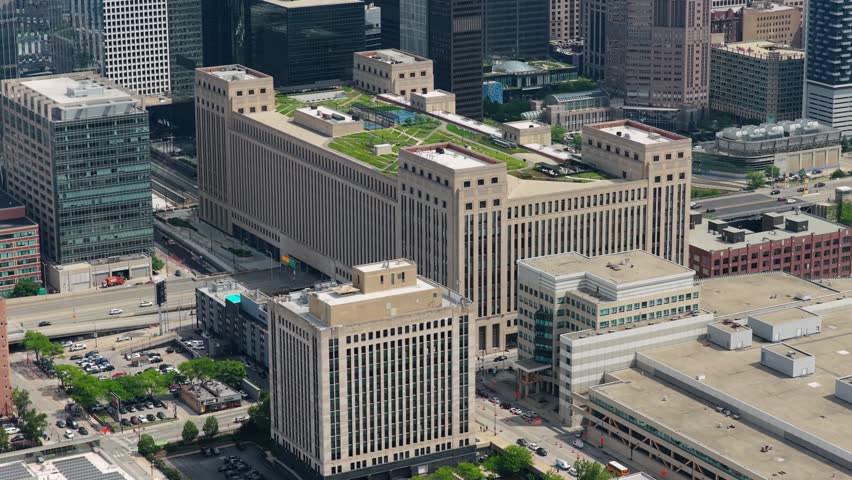 Old Chicago Post Office building with green roof and surrounding skyscrapers showing downtown Chicago architecture and busy freeway traffic flowing