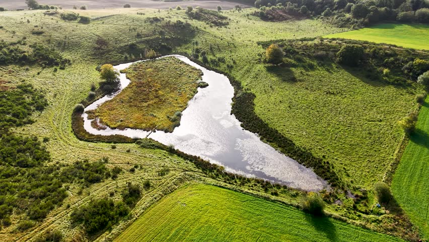 Aerial view of lush farming pond in central Jutland, Denmark
