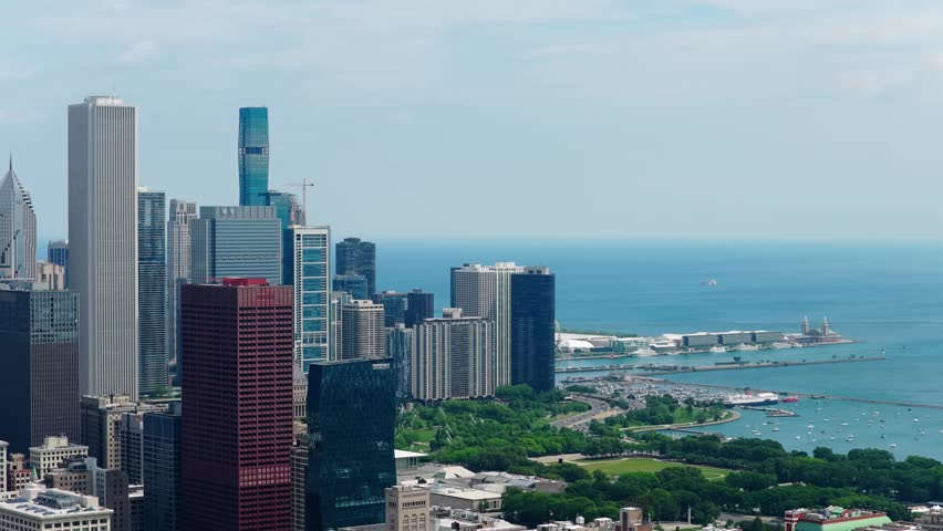 Urban landscape showcasing Chicago downtown skyline with modern skyscrapers, Grant Park, Navy Pier, and Monroe Harbor on Lake Michigan