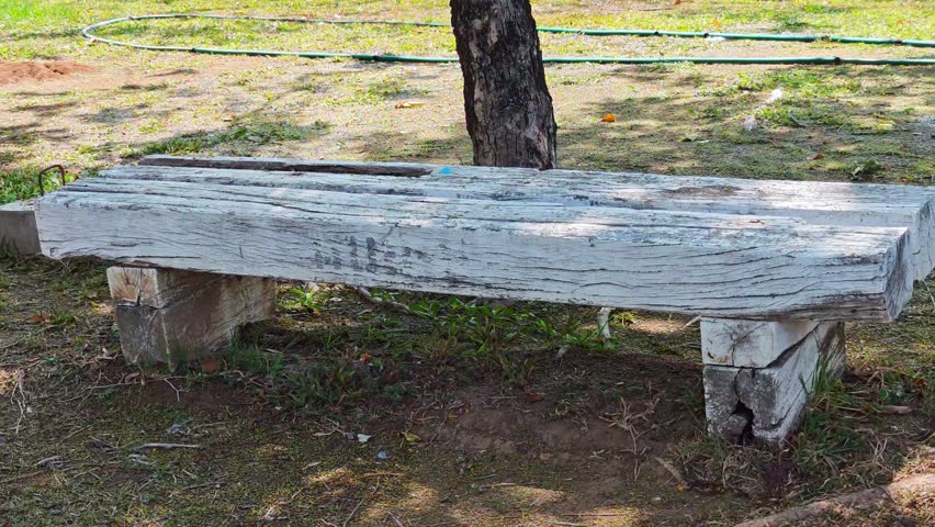 A long wooden bench in a park.