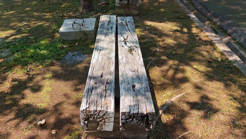 A long wooden bench in a park.