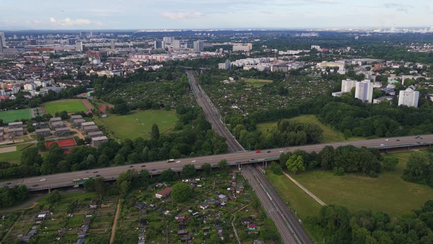 Aerial perspective of urban landscape in Frankfurt featuring autobahn bridge over a railway, green spaces, city districts in Germany