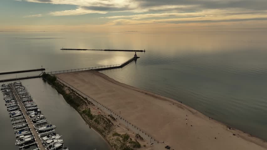Drone view of Lake Michigan and lighthouse at sunset