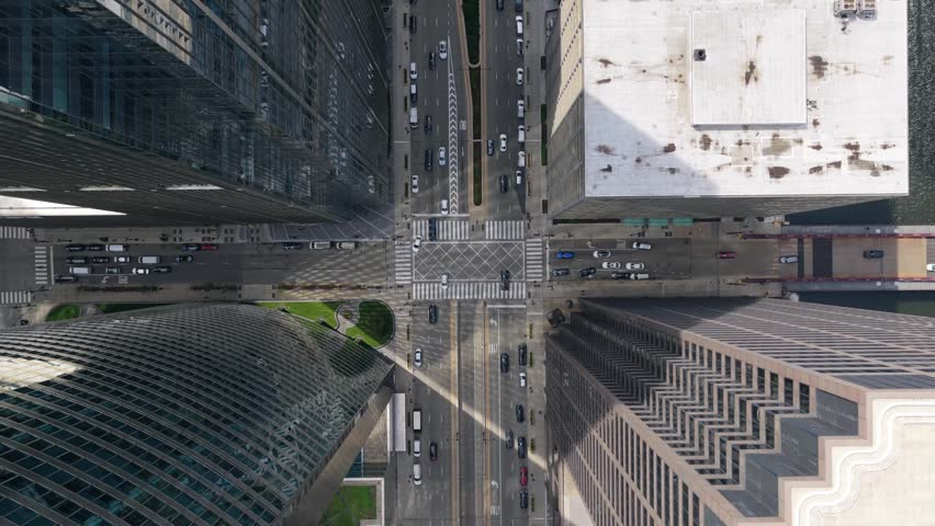 Urban canyon top down showing Chicago Riverwalk and high rise modern skyscrapers with traffic on Wacker Drive, Lake Street and Wells Street bridge