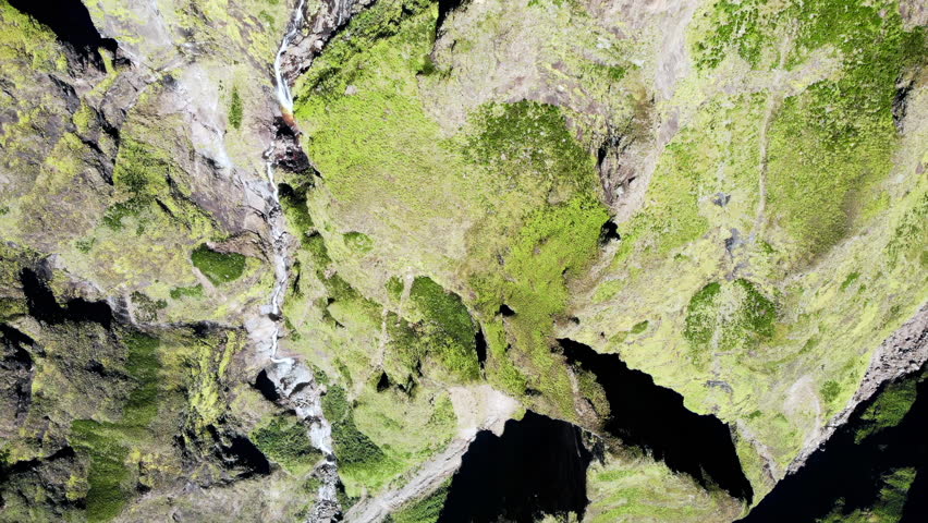 Aerial view of a moss-covered rock cliff