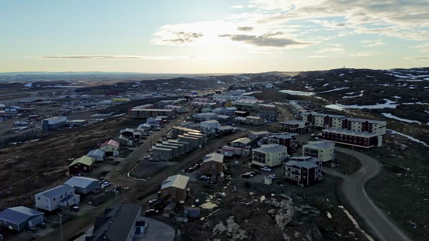 High-altitude drone perspective showcasing the modern residential layouts and modular homes built within the high Plateau neighborhood section of Iqaluit, Nunavut.