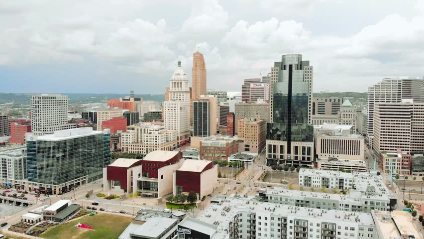 Aerial drone video of the downtown Cincinnati skyline featuring modern skyscrapers, busy streets, urban transportation networks, and iconic city architecture. Cinematic 4K footage showcasing vibrant city life, infrastructure, and metropolitan development.
