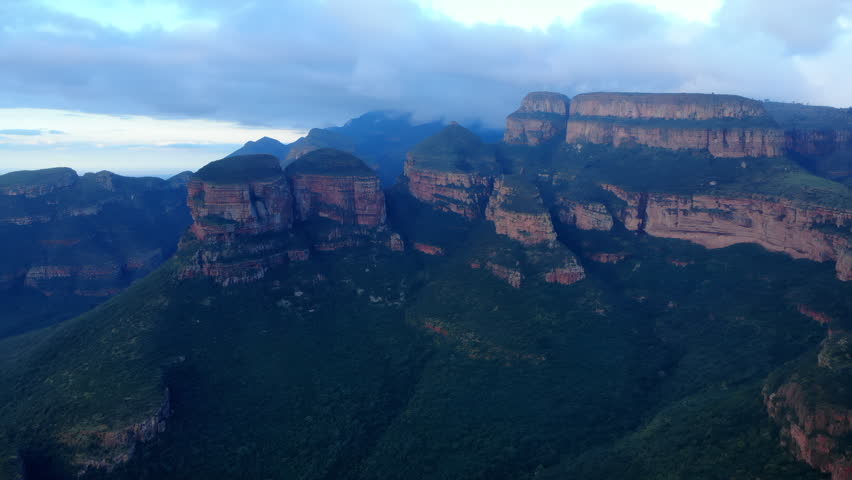 Aerial view of a rugged mountain plateau above dense forest
