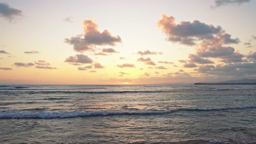 Sea sunset landscape, view from the beach. Beautiful summer seascape. Evening sun glare on the water. Sea waves against the sunset. Colorful dusty sky with pastel clouds. Twilight over the sea.