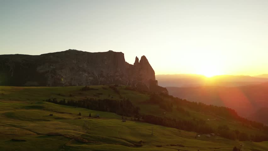 morning mountain scene, dawn over rocky terrain, golden morning light bathes jagged cliffs and lush