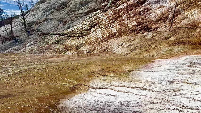 Hot water running down rock and mineral formations at  colorful hot springs