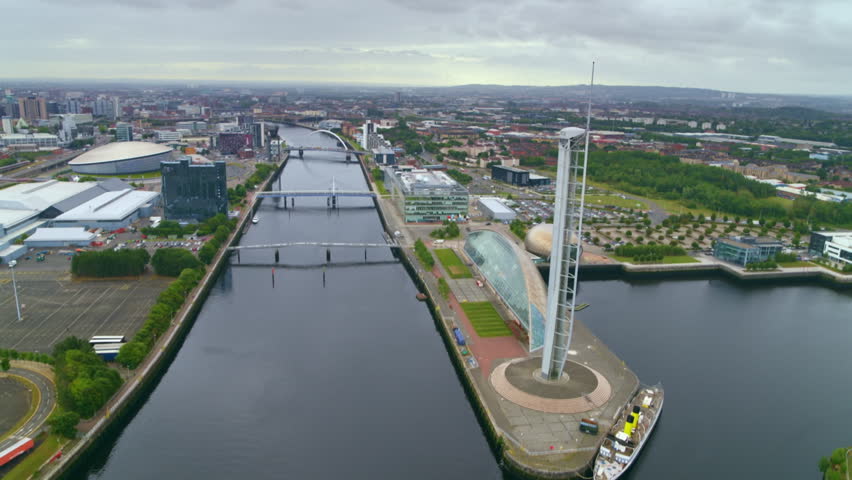 Aerial footage moving past the Glasgow Tower revealing the city skyline and the River Clyde