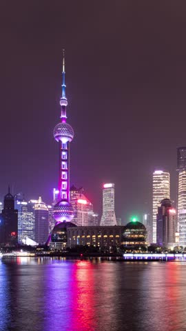 Time Lapse of tall skyscrapers of Shanghai China skyline at night. Vertical video.