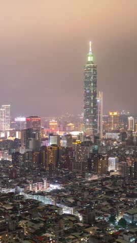 Time Lapse of low clouds above the skyline of Taipei Taiwan at night. Vertical video.