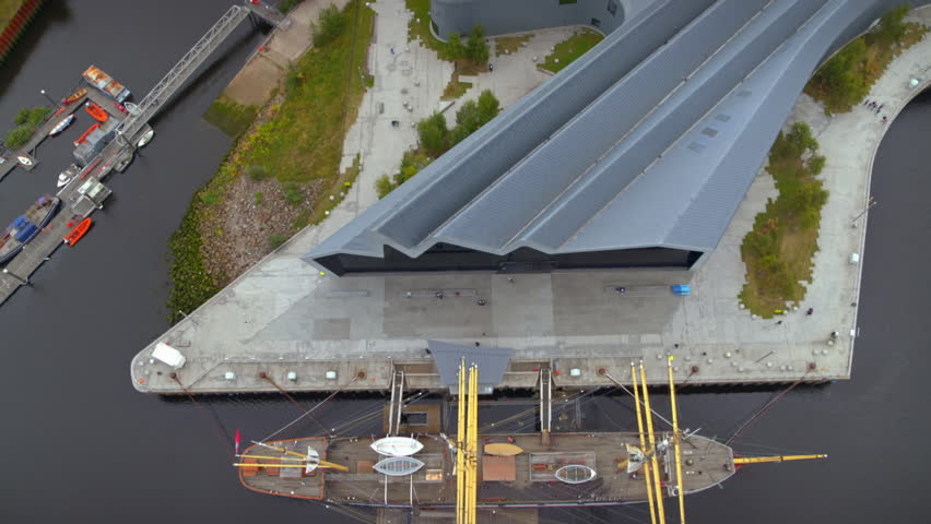 Vertical aerial perspective flying over the Riverside Museum and the tall ship Glenlee on River Clyde