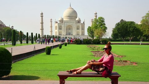 gorgeous caucasian woman posing in front of Taj Mahal
