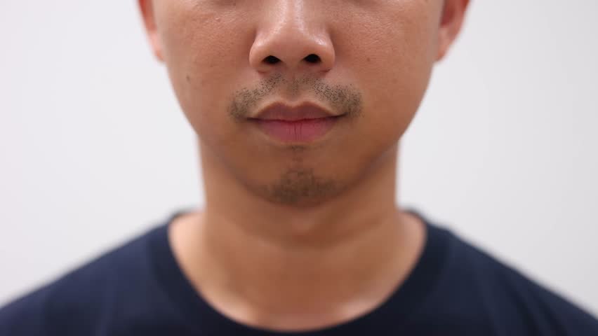 Close up face of asian man smile slow motion 