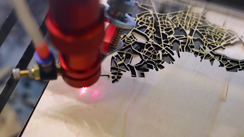 Laser engraving city map on wood precision cutting detail.