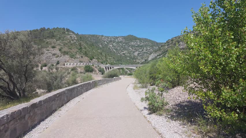 Pont du Diable Bridge Spanning Verdant Gorge in Occitanie, France