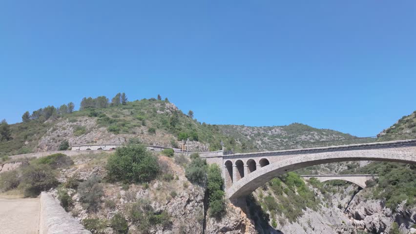Pont du Diable Bridge Spanning Verdant Gorge in Occitanie, France