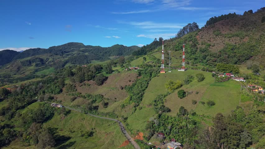 Aerial view of lush green hills and rural landscape near Jerico, Colombia on sunny day