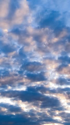 Dynamic motion of dark, heavy clouds drifting across sky during sunset. Atmospheric lighting and dramatic sky.