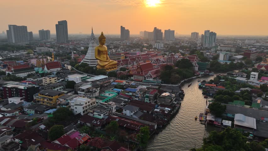 Wat paknam phasi charoen golden buddha statue sunset light aerial view travel in Bangkok Thailand