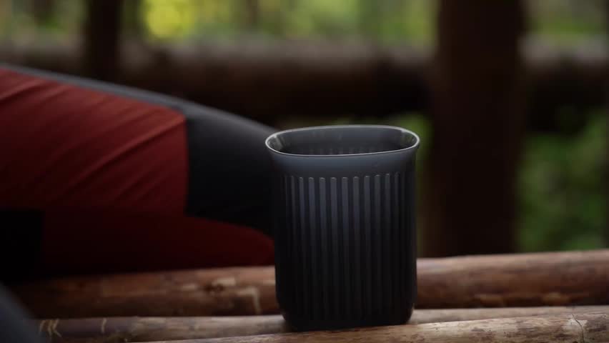 Camping coffee. Exploring the art of brewing coffee in the forest using a simple drip method and natural surroundings. Carpathian mountains, Ukraine