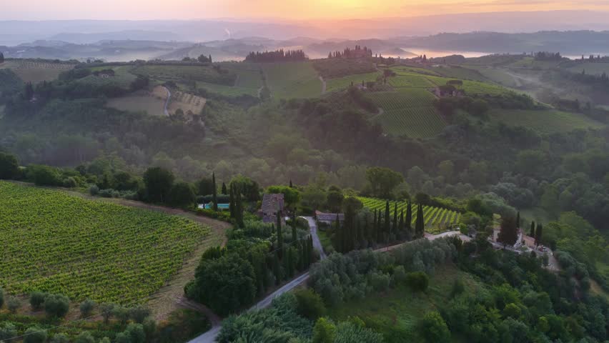Beautiful foggy morning in Tuscany, rolling hills and vineyards at sunrise, drone view, Tuscany landscape, travel in Italy, drone view of Tuscan countryside