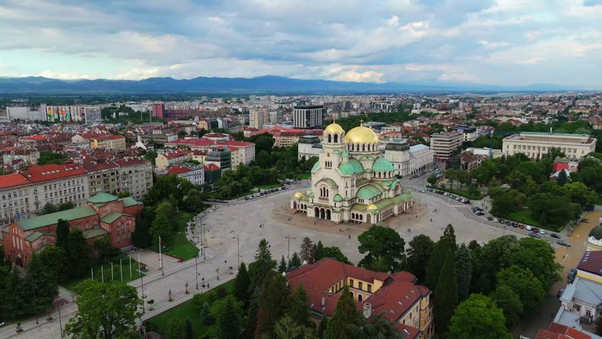 High altitude drone panorama of the historic Alexander Nevsky Cathedral in Sofia. Aerial view of the Bulgarian capital city center with green parks
