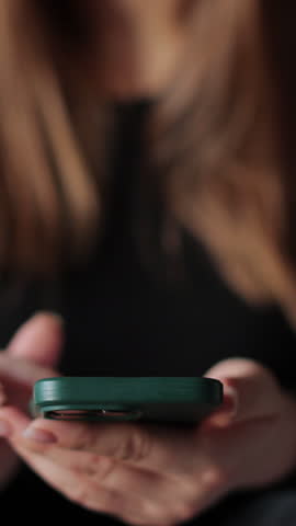 Vertical video Woman holds smartphone giving good review at cafe. Close up on female hand holding smartphone rating of the quality of service,store, service and social networks. Graphic animation.