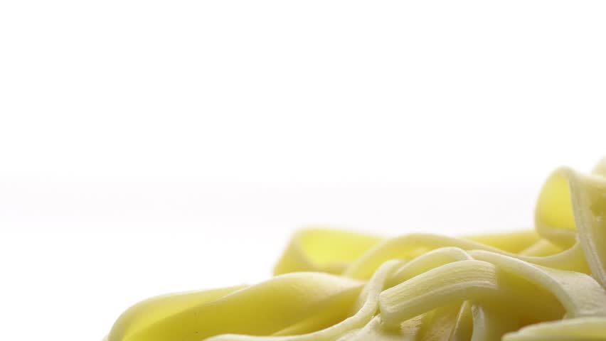 Tomato sauce is added to pasta on a white background, spaghetti and ketchup view close up